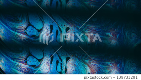 Oil spill. Psychedelic texture. Defocused blue purple colorful ink chemical round drop floating on abstract dark black background. Oil spill. Psychedelic texture. Defocused blue purple colorful ink chemical round drop floating on abstract dark black background. 139733291