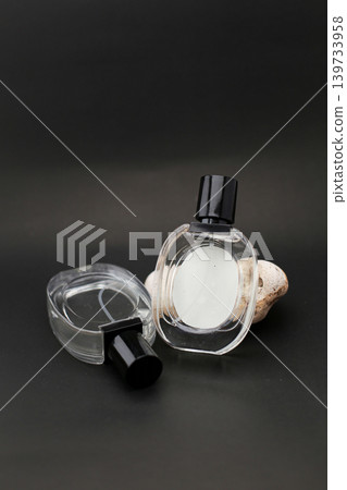 Elegant Three Glass Perfume Bottles Against a Minimalist Dark Background. Elegant Three Glass Perfume Bottles Against a Minimalist Dark Background. 139733958