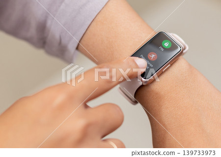 Close up of woman's hand touching smartwatch screen to start fitness tracking application. Concept of wearable technology, health monitoring, and digital sport activity Close up of woman's hand touching smartwatch screen to start fitness tracking application. Concept of wearable technology, health monitoring, and digital sport activity 139733973