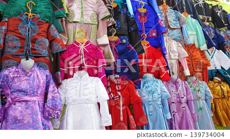 Mongolian traditional clothing, deel; colorful traditional clothing; Narantuul Market, Ulaanbaatar 139734004