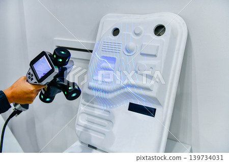Engineer using portable 3D laser scanner for industrial quality control inspection 139734031