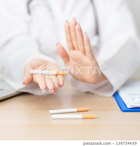 doctor hand making stop sign to refuse and breaking cigarette, quitting smoking for healthy lungs, prevent Lung Cancer and Emphysema, World No Tobacco Day concept 139734439