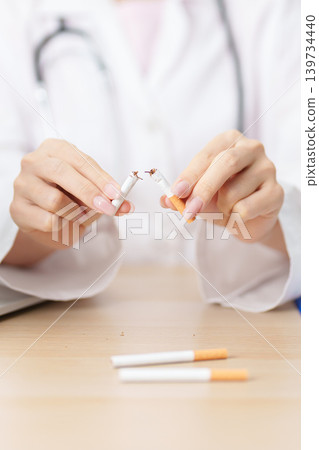 doctor hand making stop sign to refuse and breaking cigarette, quitting smoking for healthy lungs, prevent Lung Cancer and Emphysema, World No Tobacco Day concept 139734440