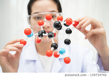 Scientist holding molecular model for chemical technology. Scientist holding molecular model for chemical technology. 139734748