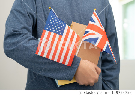 Learn English language, Asian teenage student hold book with flag in course at school. Learn English language, Asian teenage student hold book with flag in course at school. 139734752
