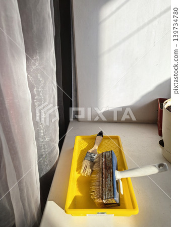 Paint Roller Tray On Windowsill During Renovation 139734780