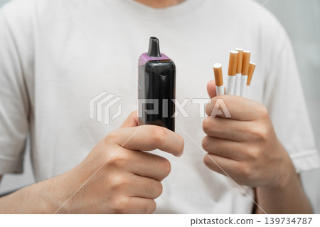 Man holding electronic cigarettes, no smoking. Man holding electronic cigarettes, no smoking. 139734787
