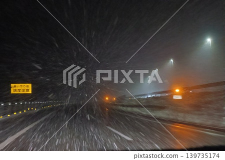 A mountain highway suddenly hit by a blizzard. A mountain highway suddenly hit by a blizzard. 139735174