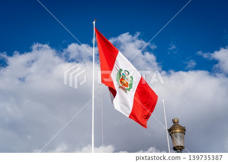 Peruvian National Flag Waving Against a Bright Blue Sky Peruvian National Flag Waving Against a Bright Blue Sky 139735387