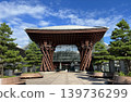 The Tsuzumi Gate of Kanazawa Station stands out against the blue sky. 139736299