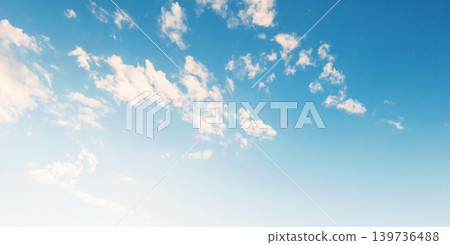 Soft clouds drift across a bright blue sky Soft clouds drift across a bright blue sky 139736488