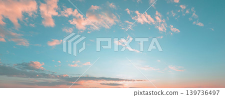 Soft clouds drift across a serene blue sky 139736497