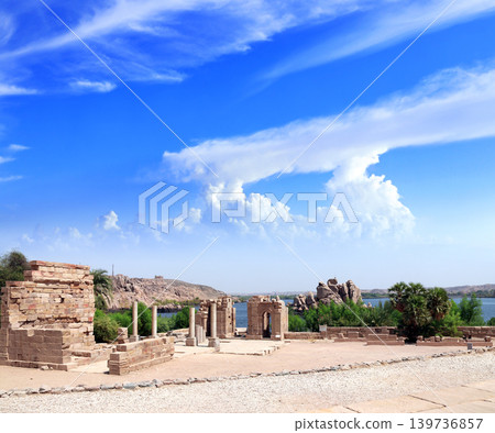 Picturesque view from ruins of temple of Isis on Agilkia Island (Philae) at reservoir of Aswan Low Dam, Egypt. Summer vacation, relaxing on cruise ship. Topic of travel, trip, cruises, tour Picturesque view from ruins of temple of Isis on Agilkia Island (Philae) at reservoir of Aswan Low Dam, Egypt. Summer vacation, relaxing on cruise ship. Topic of travel, trip, cruises, tour 139736857