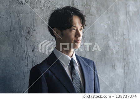 Portrait of a young male businessperson in a suit Portrait of a young male businessperson in a suit 139737374