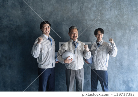 A group of male workers making a victory pose. A group of male workers making a victory pose. 139737382