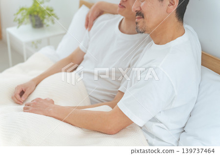 Two men cuddling in bed; homosexuality; LGBT 139737464