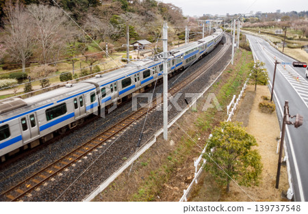 A Joban Line train passing by Mito Kairakuen Garden. A Joban Line train passing by Mito Kairakuen Garden. 139737548