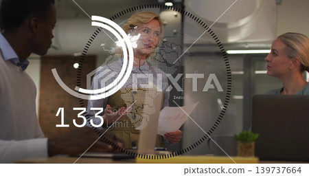 Presenting blonde woman in blazer holding pages in glass room with laptop plant yellow folder HUD Presenting blonde woman in blazer holding pages in glass room with laptop plant yellow folder HUD 139737664