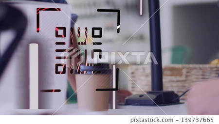Sitting disposable paper cup waiting on cafe counter, showing QR code with payment terminal 139737665