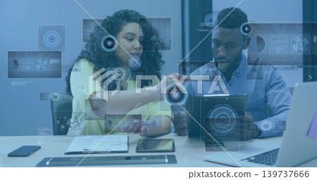 Pointing and explaining, pair in yellow blouse, light blue shirt holding tablet with AR graphics 139737666