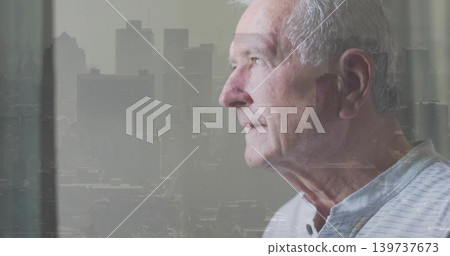 Gazing man looking out window at skyline overlay and drape, wearing striped shirt, copy space 139737673