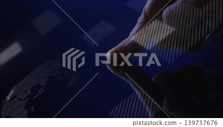 Pressing right fingertip wearing dark sleeve on glossy screen in dim workspace, with world map Pressing right fingertip wearing dark sleeve on glossy screen in dim workspace, with world map 139737676