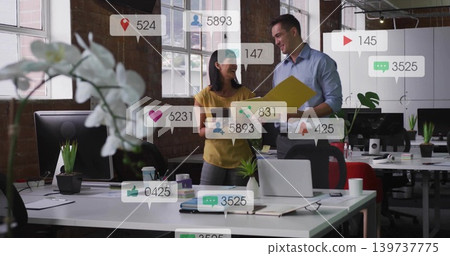Reviewing coworkers in casual wear checking yellow folder and tablet in office, orchid social-icons Reviewing coworkers in casual wear checking yellow folder and tablet in office, orchid social-icons 139737775