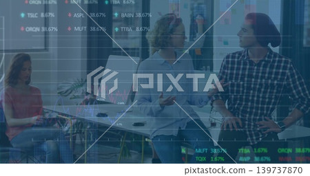 Discussing team wearing light blouse and plaid shirt at high table, with laptop, tablet and charts Discussing team wearing light blouse and plaid shirt at high table, with laptop, tablet and charts 139737870