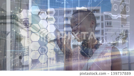 Reaching woman wearing sleeveless top, headphones using AR HUD on glass at tech lab, copy space Reaching woman wearing sleeveless top, headphones using AR HUD on glass at tech lab, copy space 139737889