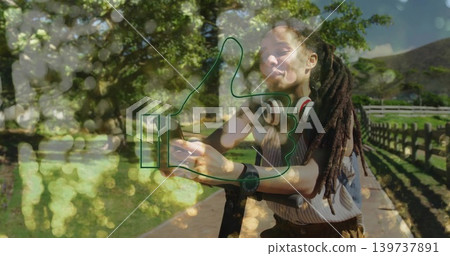 Holding smartphone, woman leaning on scooter, wearing headphones, striped top in park, thumbs-up Holding smartphone, woman leaning on scooter, wearing headphones, striped top in park, thumbs-up 139737891
