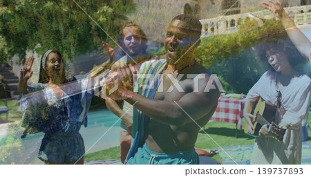 Clapping shirtless man in blue swim shorts with striped towel dancing at backyard pool, with guitar Clapping shirtless man in blue swim shorts with striped towel dancing at backyard pool, with guitar 139737893
