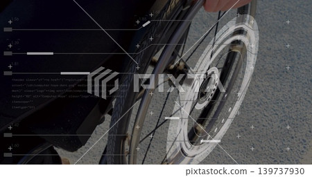 Gripping adult male hand holding wheelchair wheel on pavement, showing dark sleeve and HUD overlays Gripping adult male hand holding wheelchair wheel on pavement, showing dark sleeve and HUD overlays 139737930