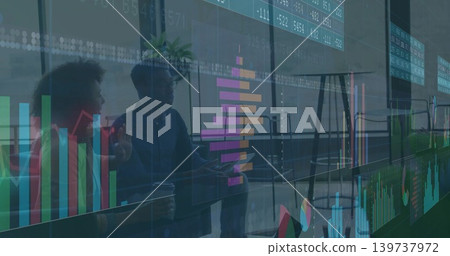 Talking team wearing business casual and blazer gesturing over overlay charts and laptop at office Talking team wearing business casual and blazer gesturing over overlay charts and laptop at office 139737972