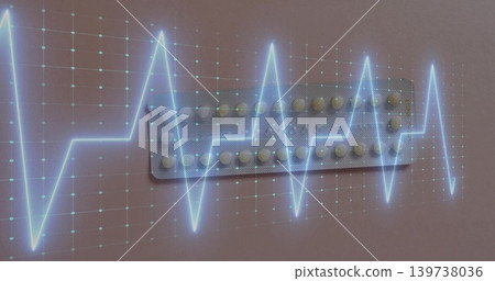 Displaying foil blister pack with tablets lying on pink-beige surface, showing ECG waveform overlay 139738036