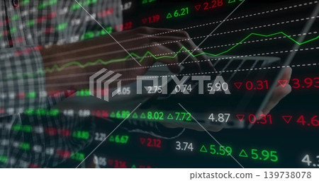 Tapping plaid-shirted man manipulating tablet at workspace, with glowing stock market graphics Tapping plaid-shirted man manipulating tablet at workspace, with glowing stock market graphics 139738078