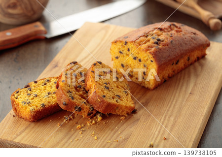 Cake with chocolate pieces on a kitchen table. Cake with chocolate pieces on a kitchen table. 139738105