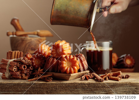 Cinnamon cakes and black coffee on an old wooden table. Cinnamon cakes and black coffee on an old wooden table. 139738109