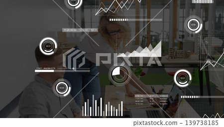 Pointing woman designer wearing glasses and man reviewing laptop and papers on wood table with HUD Pointing woman designer wearing glasses and man reviewing laptop and papers on wood table with HUD 139738185