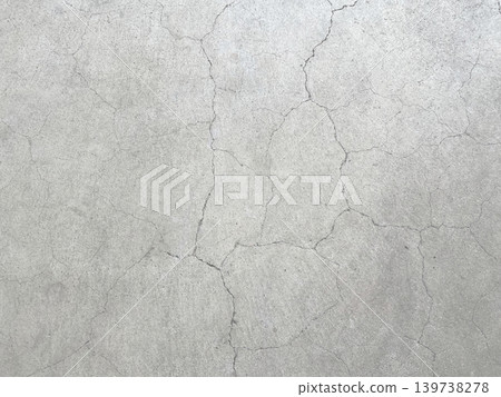 A horizontal background image of a dark, white-gray concrete wall with vertical and horizontal cracks. A horizontal background image of a dark, white-gray concrete wall with vertical and horizontal cracks. 139738278