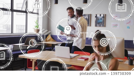 Talking team in business-casual checking teal folder and typing on laptop in coworking space, icons Talking team in business-casual checking teal folder and typing on laptop in coworking space, icons 139738309