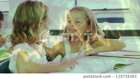 Smiling student at desk in classroom, holding pencil, in white top, with notebook and graph overlay 139738363