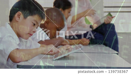 Tapping leftmost schoolboy leaning using tablet at long white table with graph overlay, copy space Tapping leftmost schoolboy leaning using tablet at long white table with graph overlay, copy space 139738367