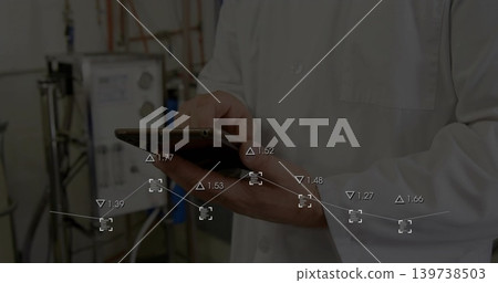 Tapping tablet, lab technician in white lab coat monitoring data overlay in lab with tanks Tapping tablet, lab technician in white lab coat monitoring data overlay in lab with tanks 139738503