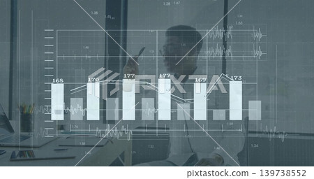 Analyzing businessman in blazer reviewing data and charts at office desk, laptop and data overlay Analyzing businessman in blazer reviewing data and charts at office desk, laptop and data overlay 139738552