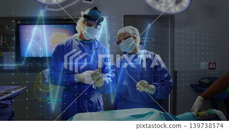Operating two surgeons pointing and talking at hospital OR in surgical gowns with ECG overlay Operating two surgeons pointing and talking at hospital OR in surgical gowns with ECG overlay 139738574