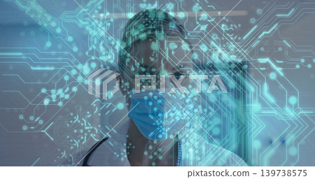 Standing clinician wearing lab coat, stethoscope, facing corridor with cyan hologram and blue mask Standing clinician wearing lab coat, stethoscope, facing corridor with cyan hologram and blue mask 139738575