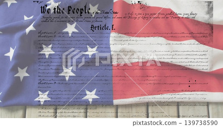Draping United States flag revealing Constitution parchment on wooden planks, showing Article 139738590