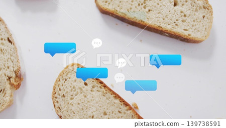 Displaying whole-grain bread slices and crumbs on white tabletop with blue and white speech bubbles Displaying whole-grain bread slices and crumbs on white tabletop with blue and white speech bubbles 139738591