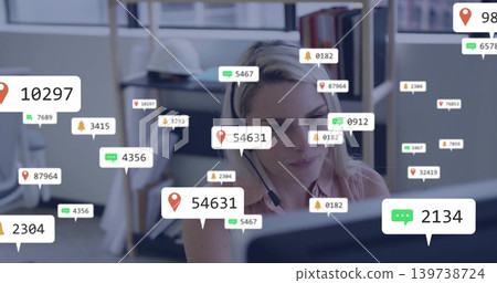 Monitoring woman in blouse with headset watching screen at office, with alerts, safety helmet Monitoring woman in blouse with headset watching screen at office, with alerts, safety helmet 139738724