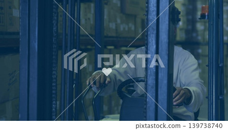 Operating forklift, male steering controls in warehouse aisle with heart overlay, wearing light top Operating forklift, male steering controls in warehouse aisle with heart overlay, wearing light top 139738740
